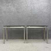 A pair of mid-century side or console tables each having a floating smoked glass top raised on