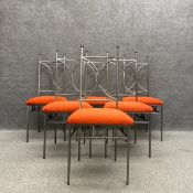 A set of six contemporary wrought steel dining chairs each having a shaped back over a rusty