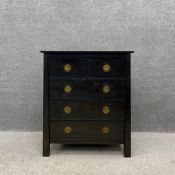 A contemporary black lacquered Indonesian hardwood chest of drawers having a moulded rectangular top
