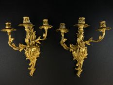 A pair of 19th century French Louis XV Rococo style gilt metal candelabra wall sconces each having a