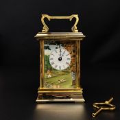 ** WITHDRAWN ** A Halcyon days brass carriage clock having a shaped swing handle above a moulded