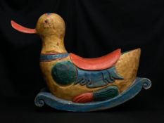 A late 20th century hand carved and painted child's rocking duck figure. H.52 W.70cm