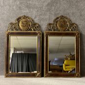 A pair of large 19th century style wall hanging mirrors each having a scrolling gilt metal