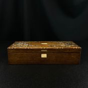 A late 19th century oak box inlaid with floral mother-of-pearl decoration to the lid. H.7 W.29cm
