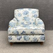 A contemporary Victorian style armchair by Wesley Barrell, having a shaped back with scrolled