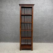 A contemporary Eastern hardwood open bookshelf having a moulded cornice above five shelves with an