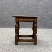 A 19th century oak jointed stool having a rectangular thumb moulded seat over four turned cup and