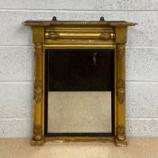 A Regency gilt and gesso framed overmantle pier mirror having an inverted break-front cornice over a
