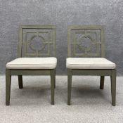 A pair of contemporary painted hall chairs each having a geometric carved splat over a slatted