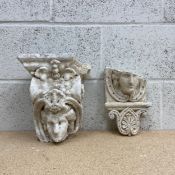 Two Victorian style Neoclassical plaster cast corbels each having a central carved face in relief in