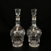 A pair of 20th century cut glass decanters with stoppers and hallmarked silver collars. H.29cm