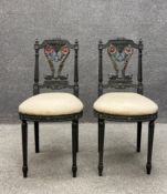 A pair of 20th century Neoclassical style chairs each having a profusely carved and painted top rail