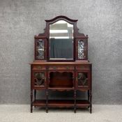 An Edwardian mahogany mirror back sideboard with a shaped and moulded pediment over a bevelled plate