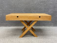 A contemporary Wem oak low side table with two short frieze drawers raised on stretchered x-frame