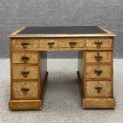 A Victorian oak and walnut twin pedestal desk having a tooled and gilt black leather crossbanded top