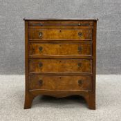 A 19th century walnut serpentine fronted bachelor's chest of drawers having a crossbanded top over a