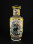 A 19th century Chinese Qing dynasty porcelain Famille Rose rouleau vase of baluster form with hand