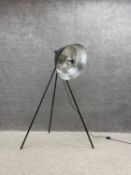 A contemporary industrial style floor standing lamp with a large shade on tripod supports. H.142cm