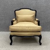 A contemporary 19th century French style armchair having a carved and shaped ebonised back and