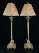 A pair gilt metal table lamps of Neoclassical form each having a pleated pale pink shade above a