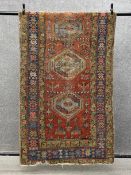 A 20th century Anatolian rug having three central lozenge medallions in duck egg blue surrounded