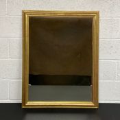 A contemporary rectangular gilt framed wall mirror with faux aged plate. H.100 W.79cm