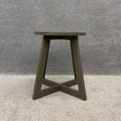 A contemporary taupe painted side table having a circular top raised on four flat stretchered