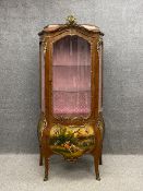 A Louis XV style vitrine or display cabinet having an arched caddy topped cornice mounted with an
