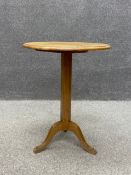 A late 19th century oak Arts and Crafts occasional table having a round moulded top over a faceted