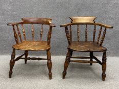 Two 19th century beech and elm smoker's bow armchairs each having a scrolled back and arms raised on