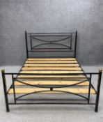 A contemporary 19th century style black painted metal bed frame with brass finials. To fit a 5 ft