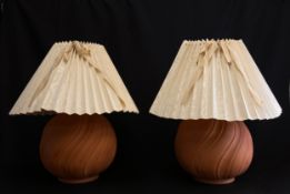 A pair of 1980's vintage hand made terracotta lamps of globular form with swirling patterns and