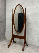 An Edwardian mahogany cheval mirror having an oval ebony and satinwood inlaid swing frame around a
