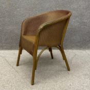 An early 20th century 'Lusty' wicker chair having a gold coloured painted finish by Lloyd Loom