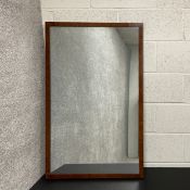 A mahogany and crossbanded dovetail jointed mirror with its original patinated mercury plate,