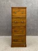 A late 19th century fruitwood filing cabinet of four drawers on a plinth base. (Veneer lifting to