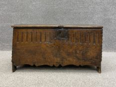 A 17th century pit-sawn oak six plank coffer having a rectangular lid with a carved edge mounted