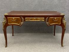 A contemporary Louis XV style ormolu mounted writing table having a brown leather top above an