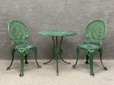 A matched set of cast and painted aluminium garden furniture to include a circular openwork bistro