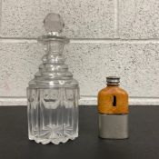 An early 20th century cut glass decanter. H.23cm together with a C.1900 tan leather clad pewter