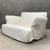A contemporary Maker & Son Otter range two seater sofa having a shaped back with flared arms over