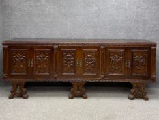 A large mahogany credenza or sideboard in the 19th century Italian style having a moulded plank