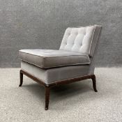 A 20th century 'Slipper' style chair having a square cushioned button back and seat upholstered in