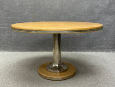 A 20th century maritime themed oak dining table having a circular top with a steel banded edge