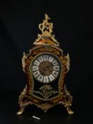 A Franz Hermle & Sons red boulle brass inlaid Louis XV style mantle clock having a gilt metal Rococo