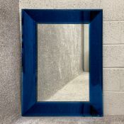 A 20th century Venetian style mirror with a mitre cut translucent blue glass cushion frame in the