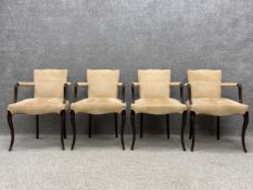 A set of four 20th century George III style open armchairs each having a shaped back with curved