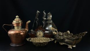 A collection of four metal items to include an Art Deco mantle clock in the form of a wooden ship