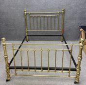A contemporary 19th century style turned and polished brass double bed frame with cup and cover