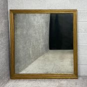 A large 20th century giltwood mirror having a square reeded mitre cut frame around a distressed